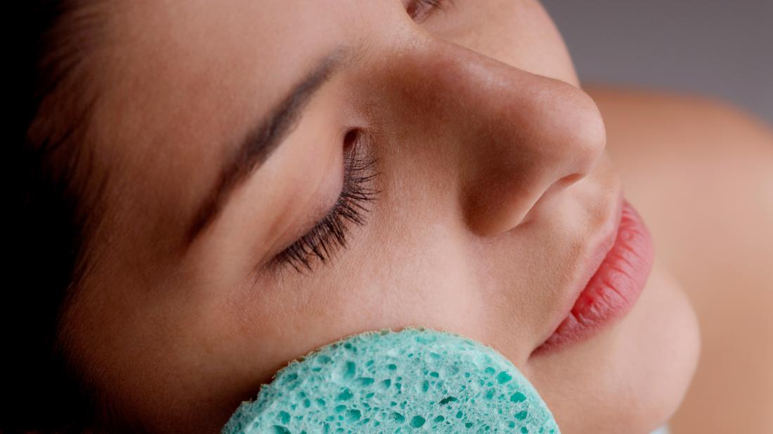 A person doing exfoliation <!--mce:protected %0A--> on their face with a spong as that is How to remove dead skin from face” class=”css-uoe8zd”></picture></span><span class=