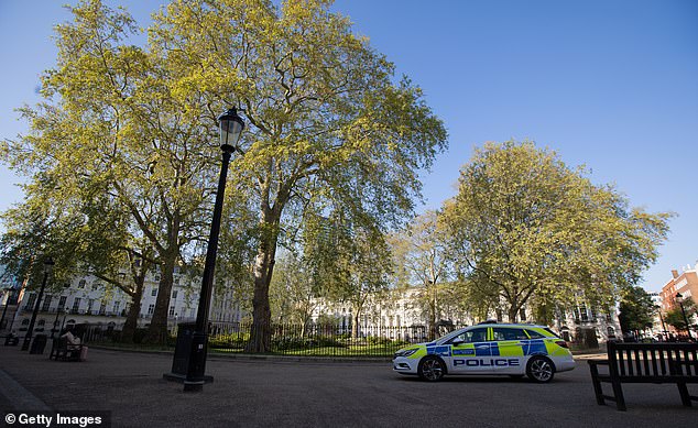 A police car in a quiet Fitzroy Square in London today. The British government has extended the lockdown restrictions first introduced on March 23