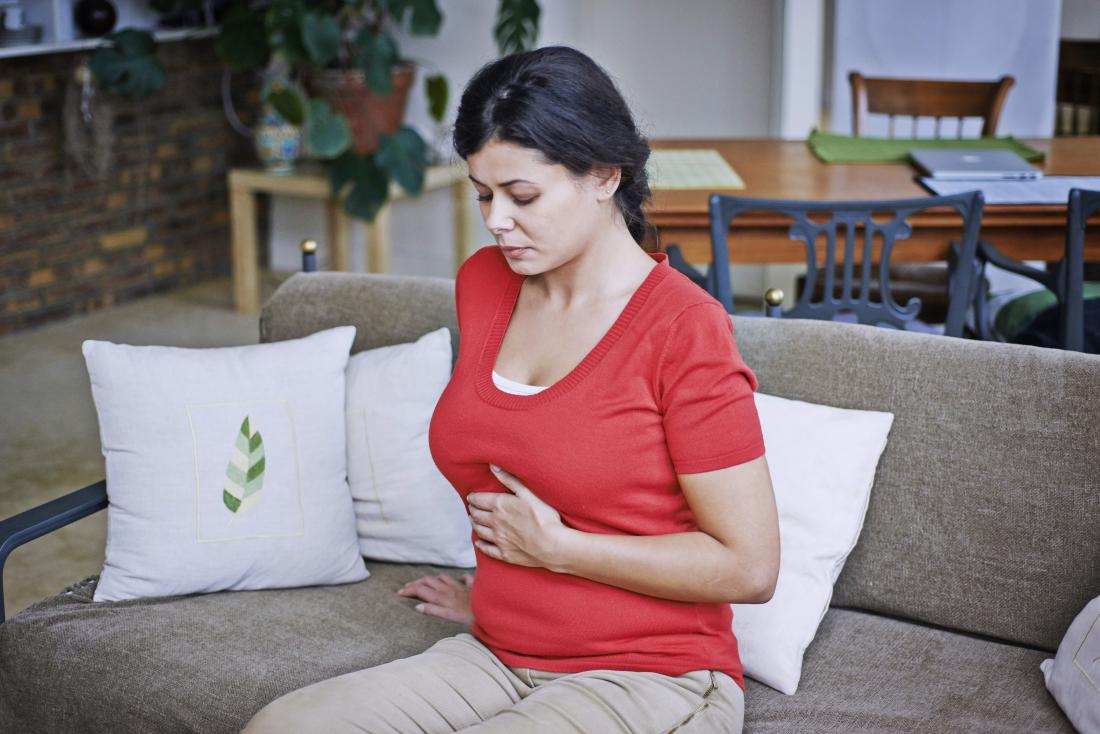Woman experiencing heartburn or gas
