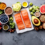 Healthy food clean eating selection: fish, fruit, vegetable, seeds, superfood, cereals, leaf vegetable