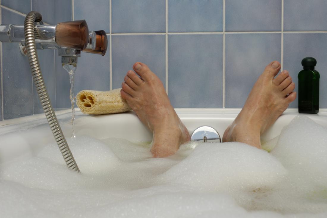 Mans feet at the end of a bath