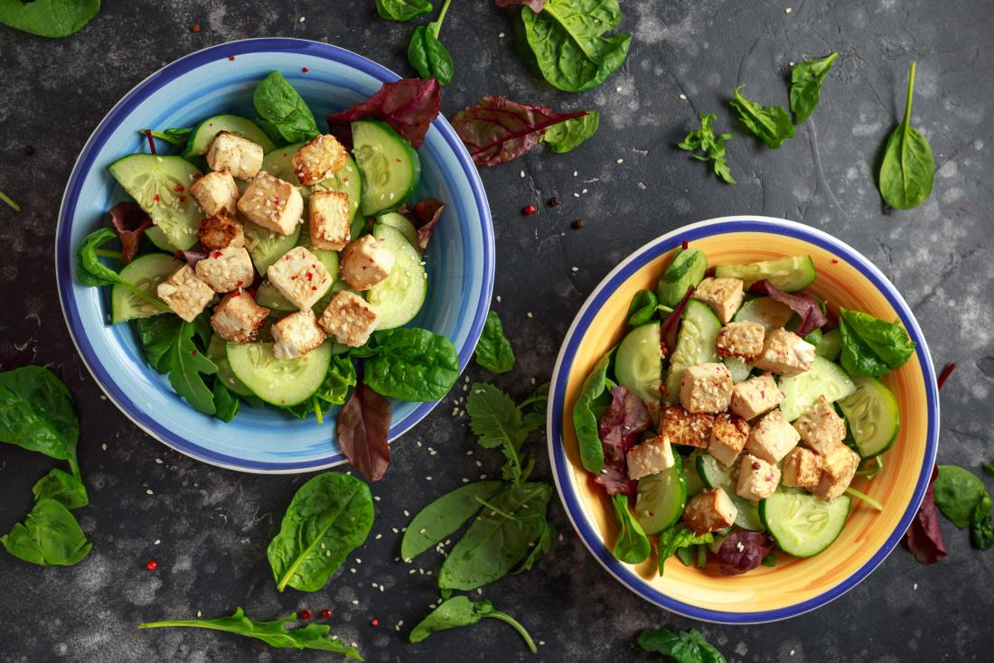 Tofu salad with seeds, spinach, and cucumber.